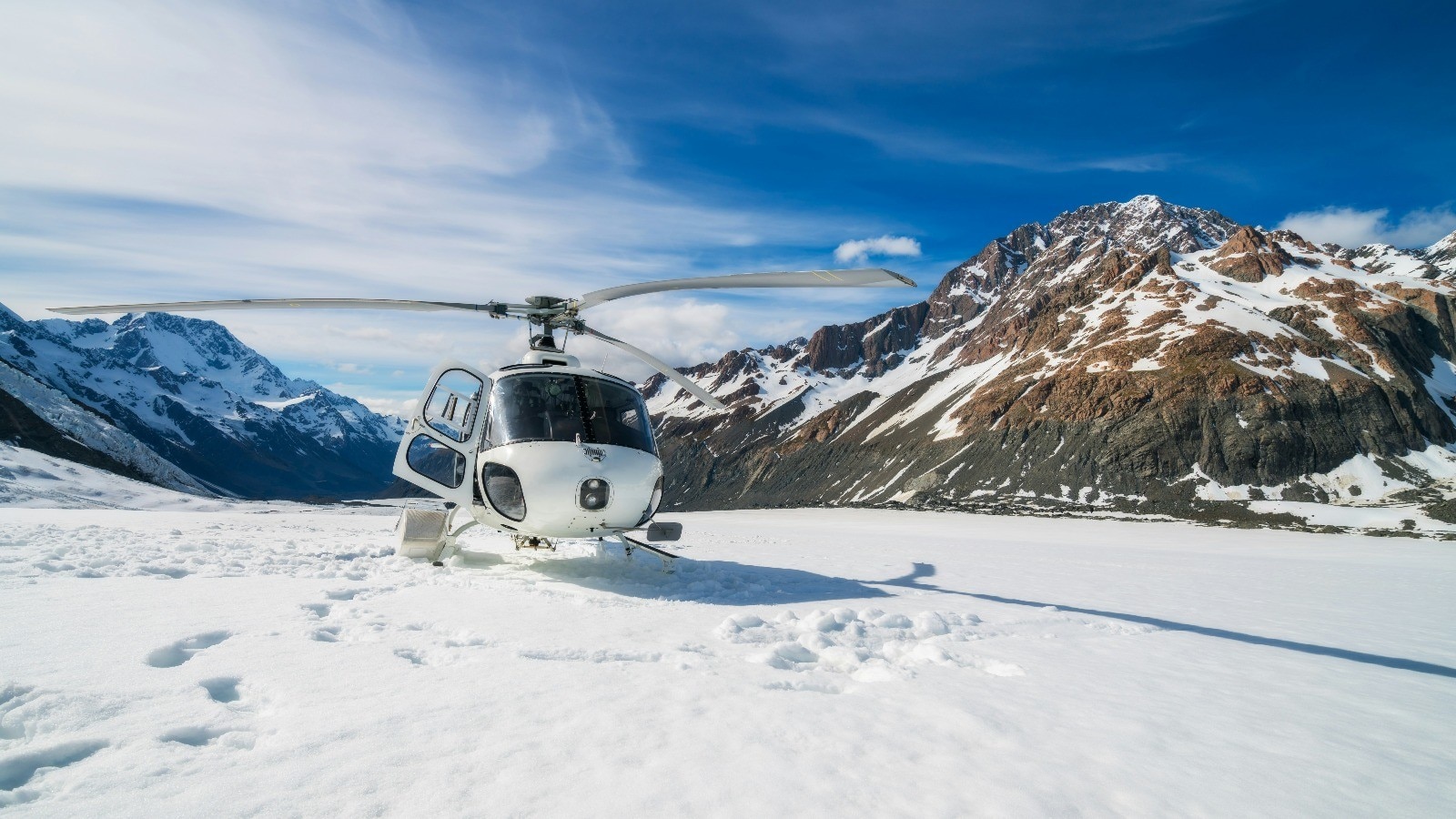 Helicopter on top of snowy mountains in New Zealand