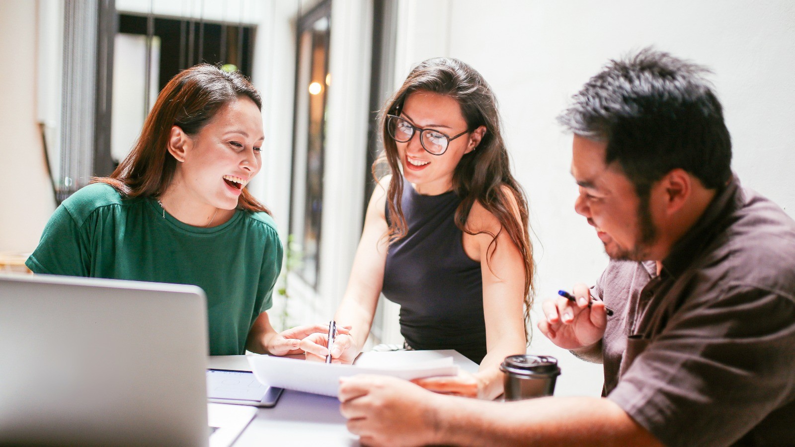 Group of colleages in a walking in a modern-designed office together.