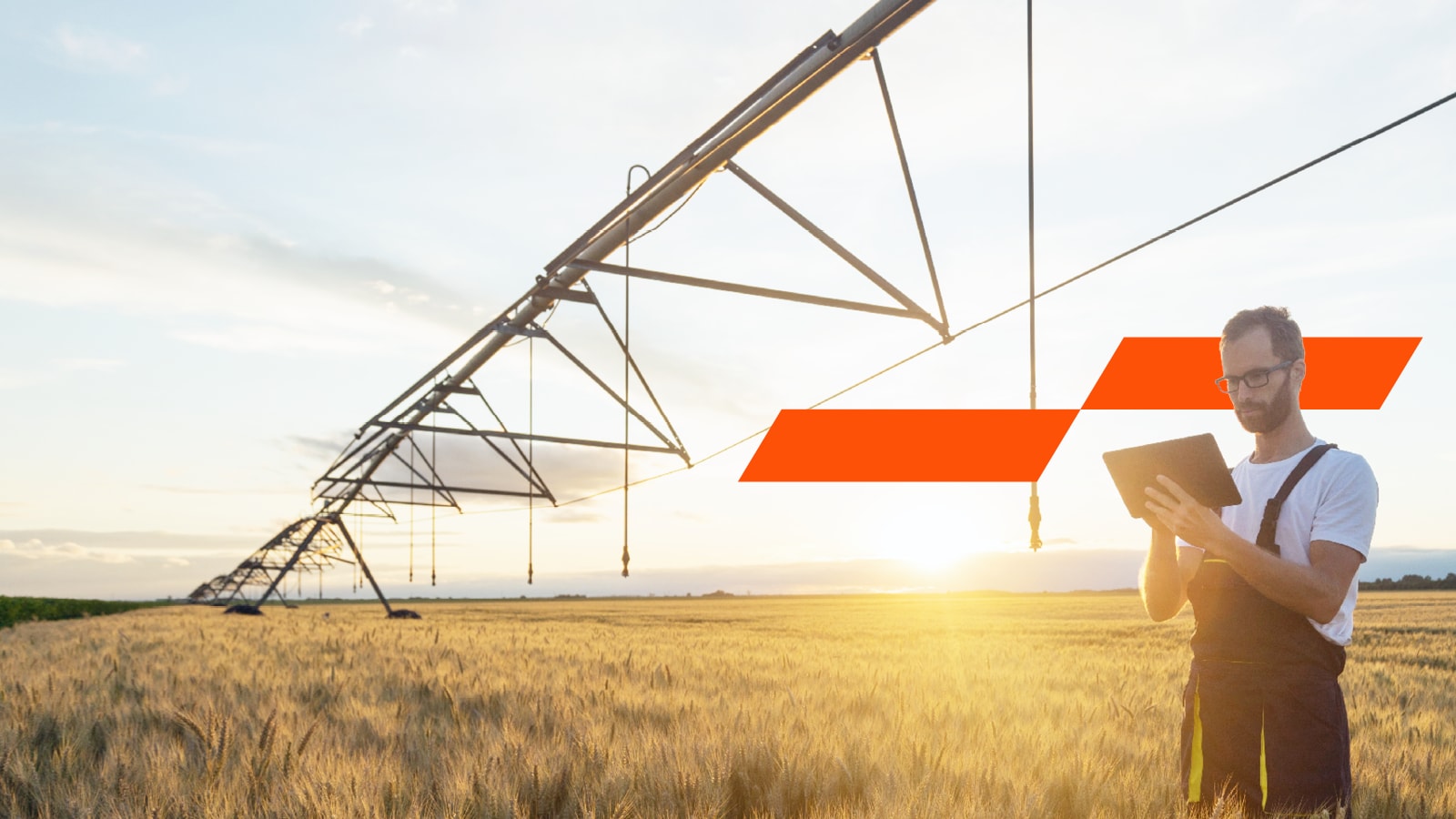 A farmer working in the field using digital technology to help with his tasks. 