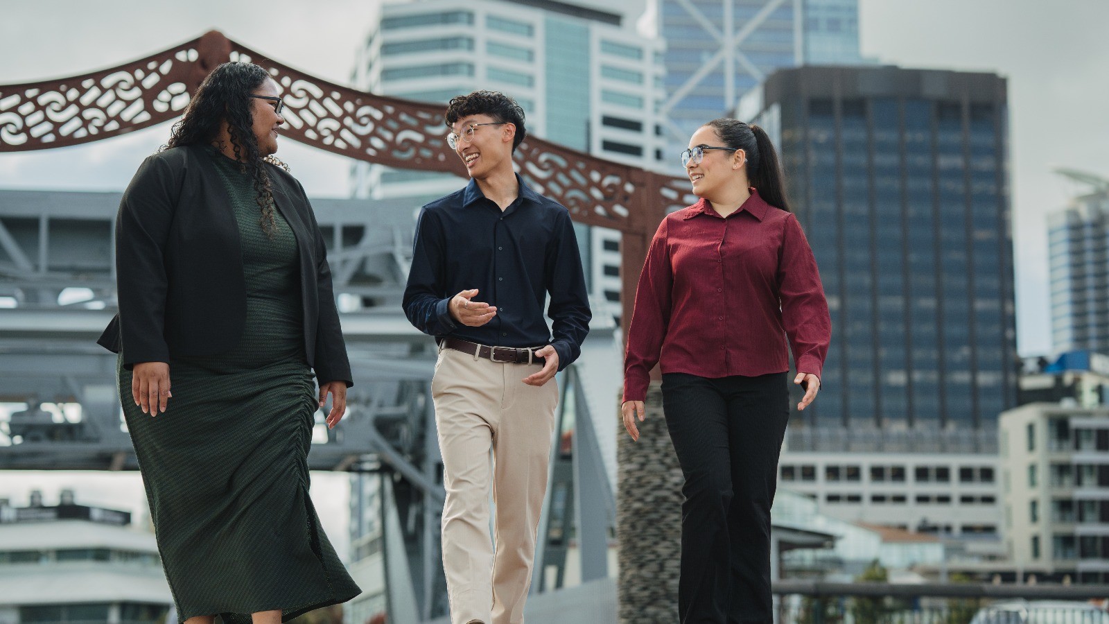 Group of young professionals chatting by the Auckland harbour