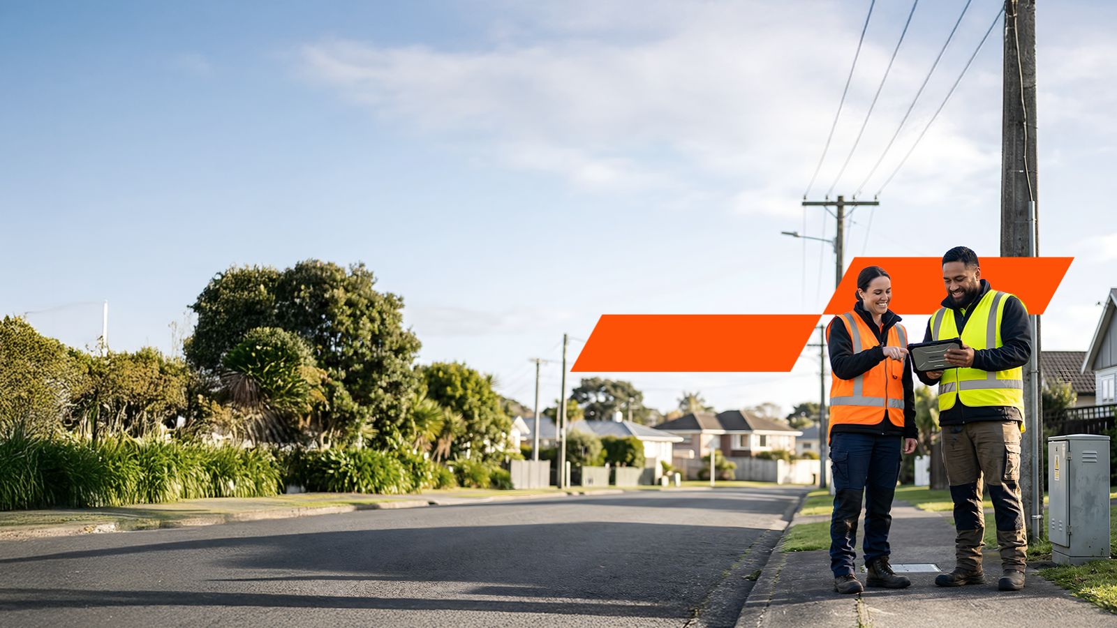 two people in high-vis on a suburban street