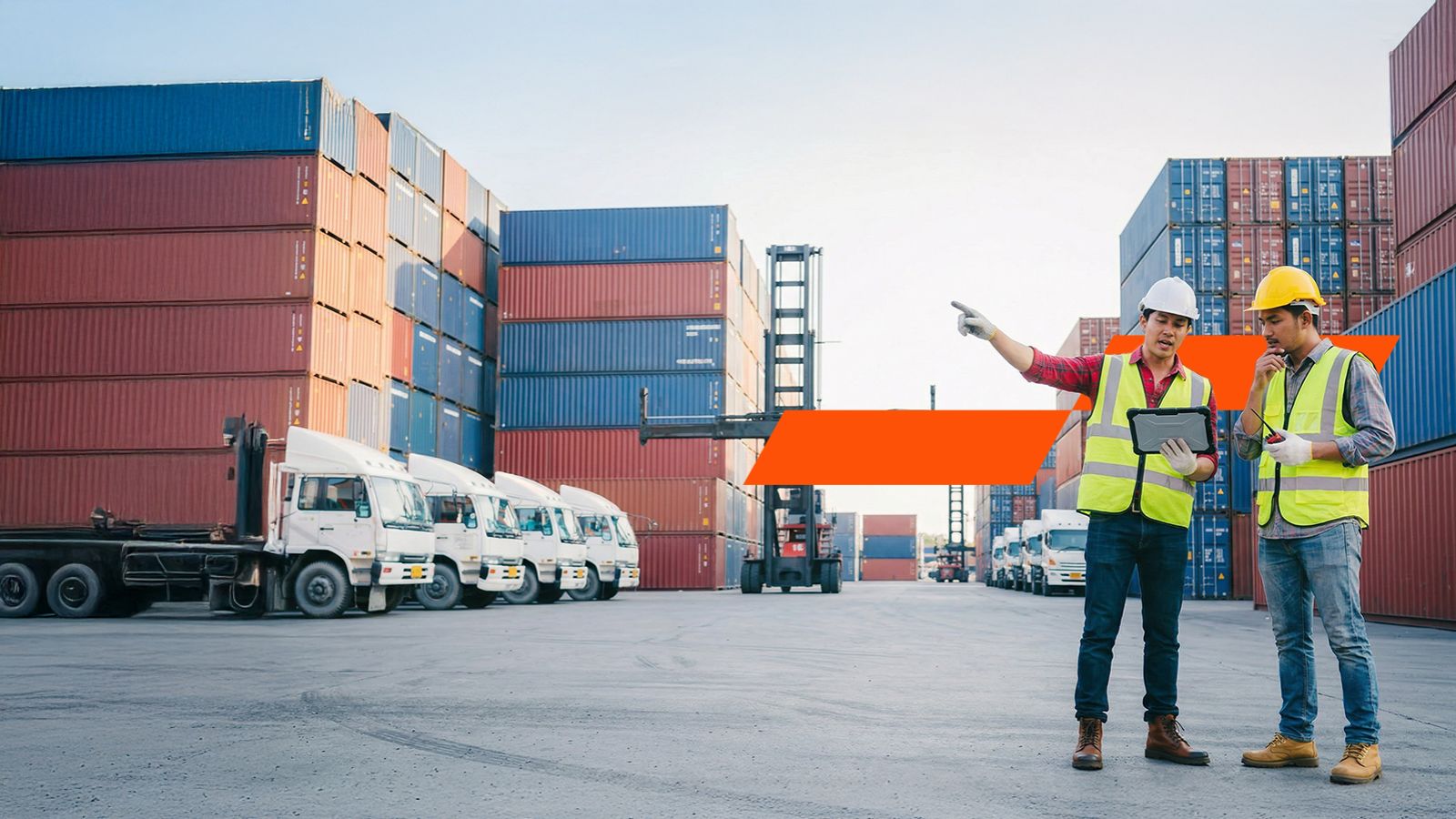 People standing talking next to shipping containers