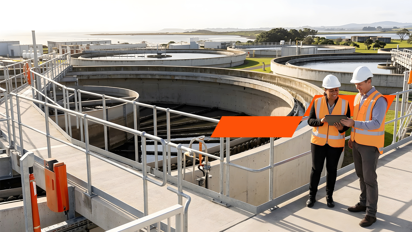 two people in high-vis at water plant