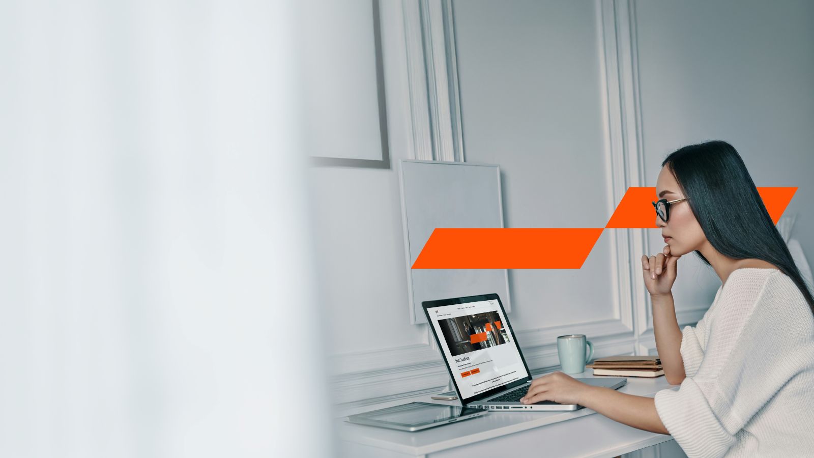 Woman working at laptop with Momentum Mark in background
